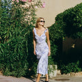 Woman wearing Olive Muse blue floral maxi dress, front view