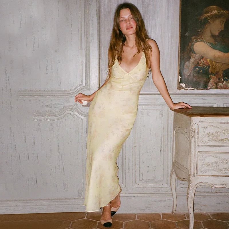Woman wearing Olive Muse yellow floral maxi dress, front view