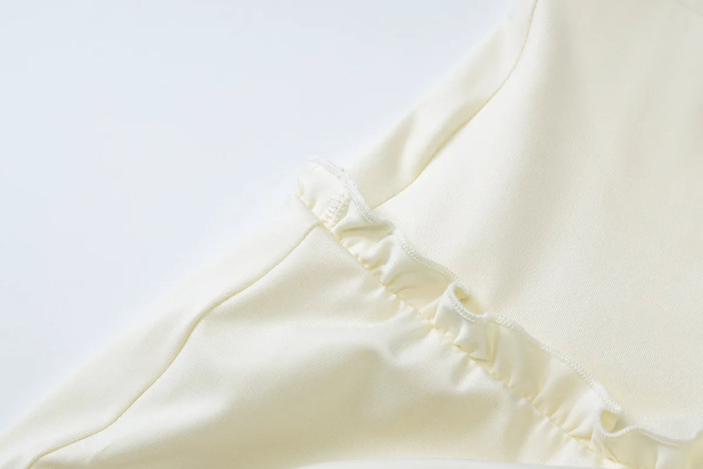 Fabric texture close-up of Olive Muse apricot halter co-ord set